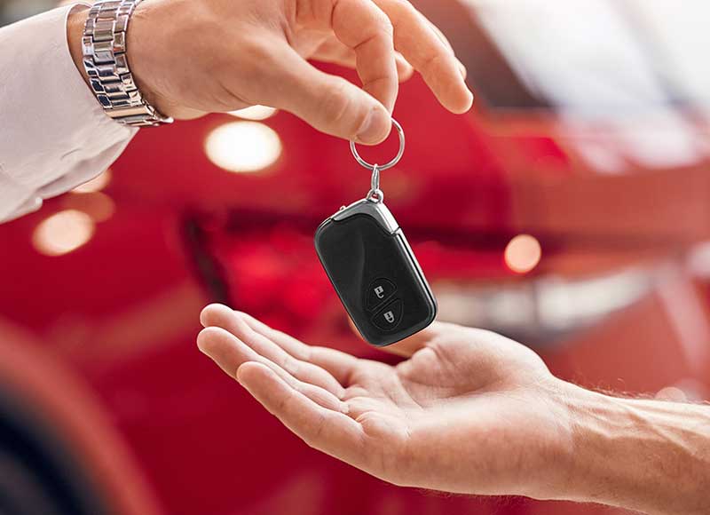 A close-up scene focused on the transfer of a car key